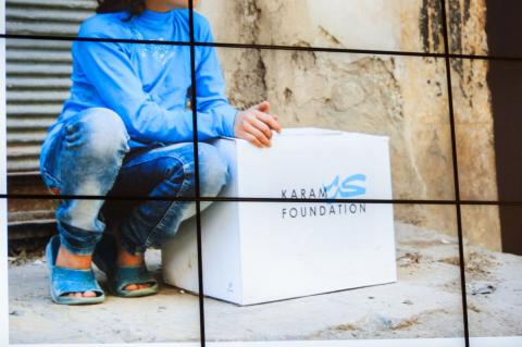 Girl sitting next to foundation titled box